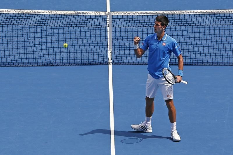 © Reuters. Djokovic of Serbia celebrates a point over Bedene of Slovenia during their men's singles match at the Australian Open 2015 tennis tournament in Melbourne