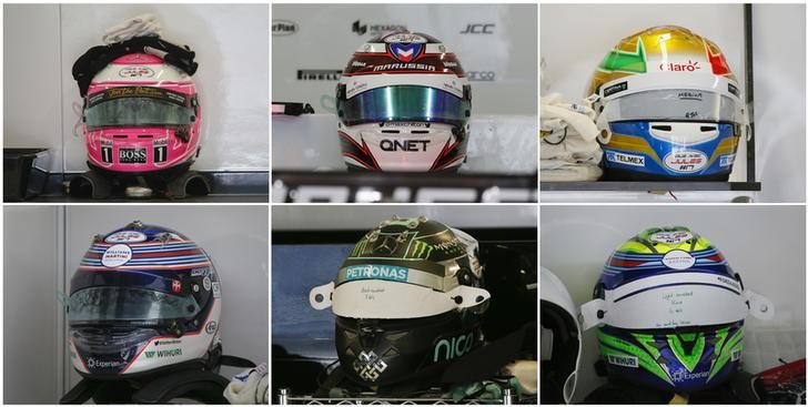 © Reuters. A combination photos shows helmets of Formula One drivers with stickers in support of Marussia F1 driver Jules Bianchi, pictured before the third practise session of the Russian F1 Grand Prix in the Sochi Autodrom circuit