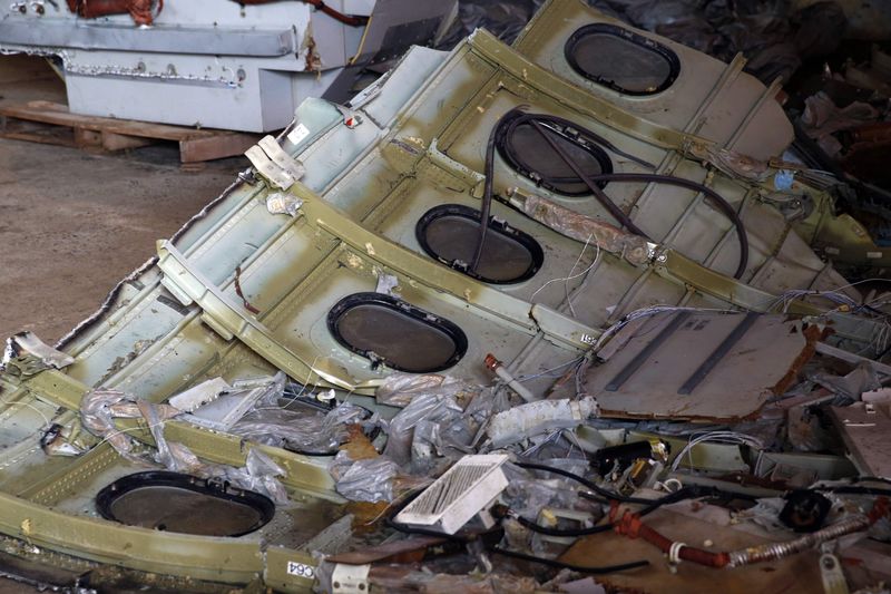 © Reuters. Part of the fuselage of crashed AirAsia Flight QZ8501 is seen inside a storage facility at Kumai port in Pangkalan Bun