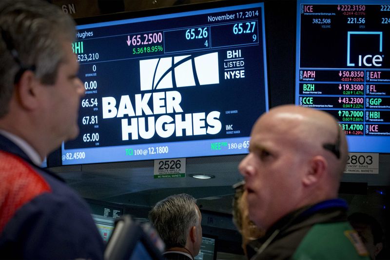 © Reuters. Traders work by the post that trades Baker Hughes on the floor of the New York Stock Exchange