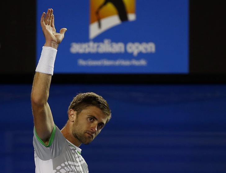 © Reuters. Smyczek of the U.S. gestures to the crowd after losing to Nadal of Spain in their men's singles second round match at the Australian Open 2015 tennis tournament in Melbourne 