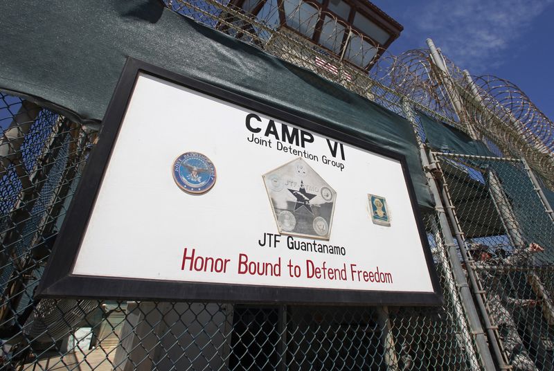 © Reuters. A guard opens the gate at the entrance to Camp VI, a prison used to house detainees at the U.S. Naval Base at Guantanamo Bay in Cuba