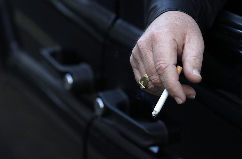 © Reuters. A man smokes in his car in London