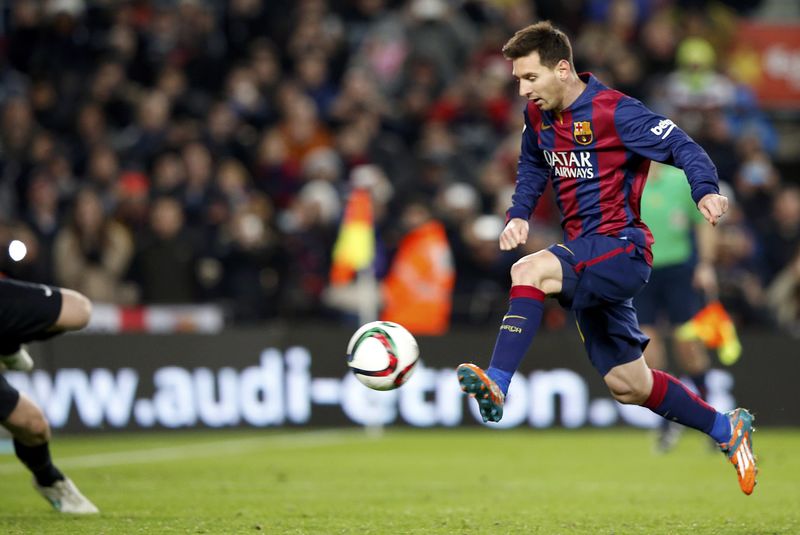 © Reuters. Barcelona's Lionel Messi kicks to score a goal during their King's Cup quarter-final first leg soccer match in Barcelona