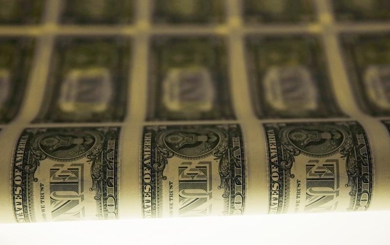 © Reuters. A sheet of United States one dollar bills is seen on a light table during production at the Bureau of Engraving and Printing in Washington