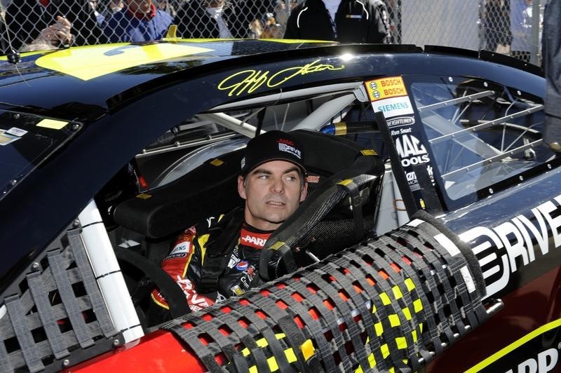© Reuters. NASCAR Sprint Cup Series driver Jeff Gordon, of the number 24 car, prepares to exit his car after his outside pole-securing run during qualifying for the Daytona 500 in Daytona Beach