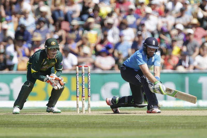 © Reuters. England's Bell reverse sweeps with Australia's Haddin watching, during their ODI tri-series cricket match in Hobart