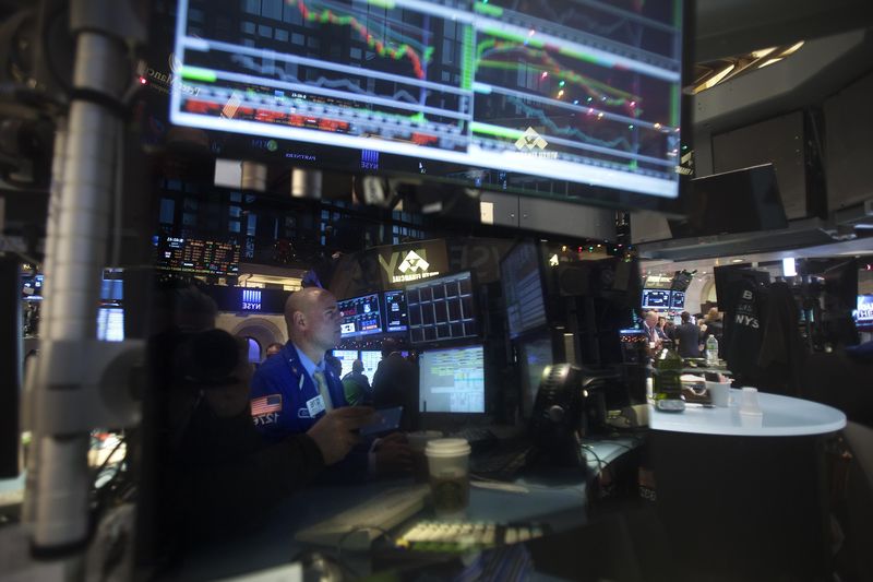© Reuters. Trader is reflected in a screen as he works on the floor of the NYSE in New York