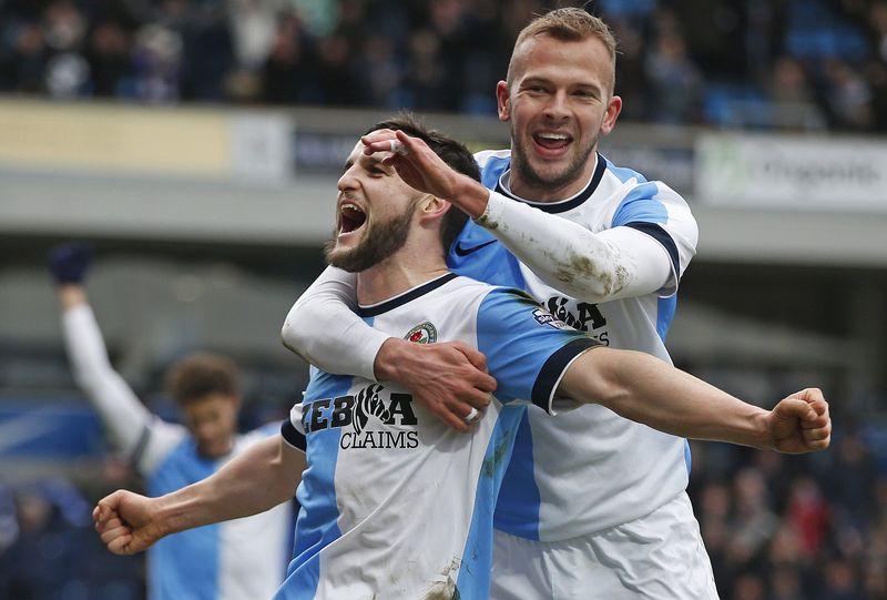 © Reuters. Blackburn Rovers' Conway celebrates after scoring his team's third goal with Rhodes during their FA Cup fourth round soccer match against Swansea City at Ewood Park in Blackburn