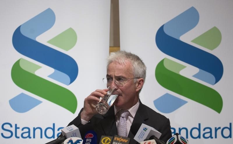 © Reuters. Standard Chartered Group Chief Executive Sands drinks during a news conference in Hong Kong