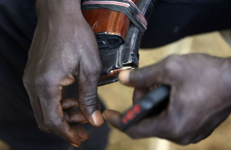 © Reuters. Leader of militia hunters helping the army to fight the Boko Haram insurgence in the northeast region of Nigeria, holds a magazine of bullets in his hands during an interview in Yola