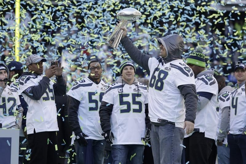 © Reuters. Seahawks' Giacomini holds the Vince Lombardi Trophy at Century Link Field after the NFL team's Super Bowl victory parade in Seattle