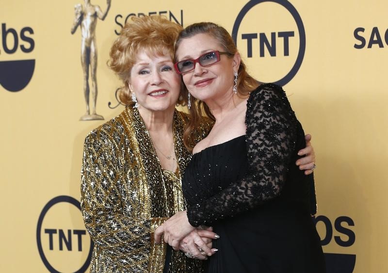 © Reuters. Actress Debbie Reynolds poses with her daughter actress Carrie Fisher backstage after accepting her Lifetime Achievement award at the 21st annual Screen Actors Guild Awards in Los Angeles