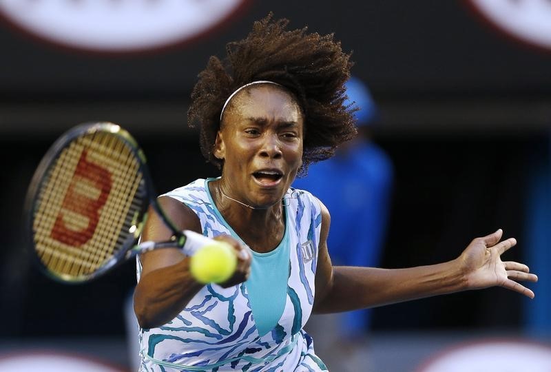 © Reuters. Venus of the U.S. hits a return to Radwanska of Poland during their women's singles match at the Australian Open 2015 tennis tournament in Melbourne 