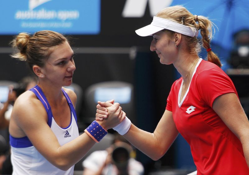 © Reuters. Makarova of Russia shakes hands with Halep of Romania after winning their women's singles quarter-final match at the Australian Open 2015 tennis tournament in Melbourne