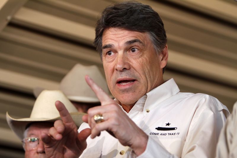 © Reuters. File photo of Texas Governor Perry answering questions from the media after aerial tour over the fertilizer plant explosion site in West, Texas