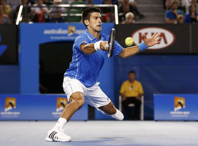 © Reuters. Novak Djokovic of Serbia hits a return against Milos Raonic of Canada during their men's singles quarter-final match at the Australian Open 2015 tennis tournament in Melbourne 