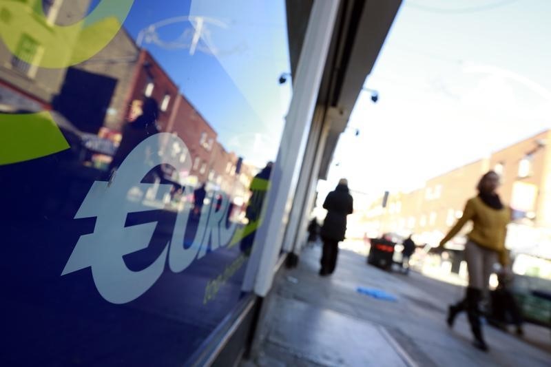 © Reuters. People walk past a discount store in the Moore Street area of Dublin