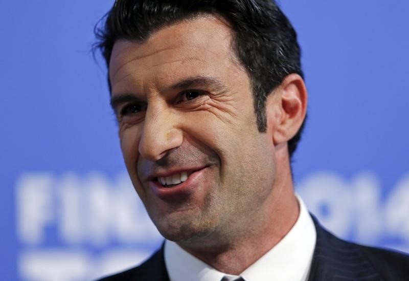 © Reuters. Figo smiles during the draw for the Champions League semi-finals matches at the UEFA in Nyon