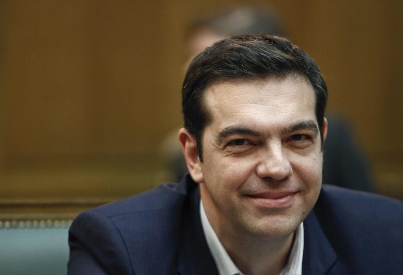 © Reuters. Greek PM Tsipras smiles as he attends the first meeting of the new cabinet in the parliament building in Athens
