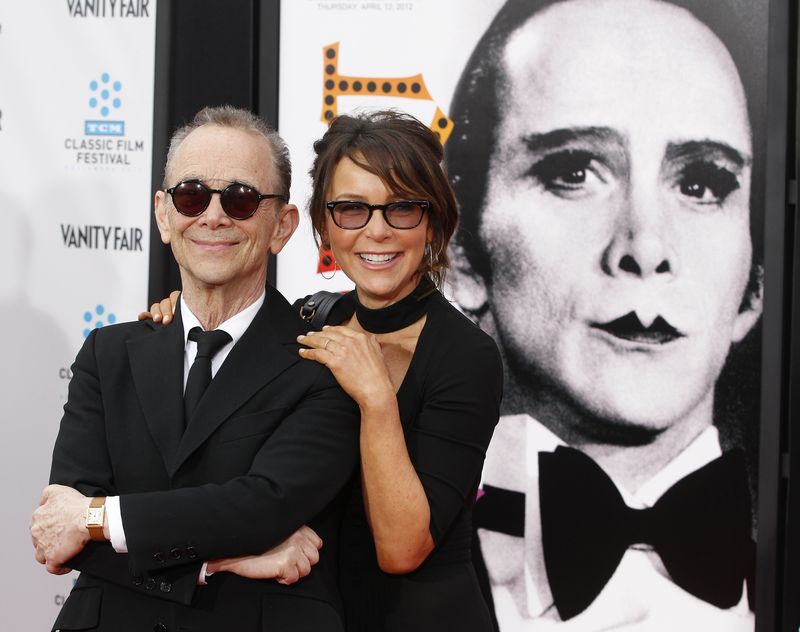 © Reuters. File photo of cast member Grey posing next to poster featuring his character in film "Cabaret", the Master of Ceremonies, in Hollywood