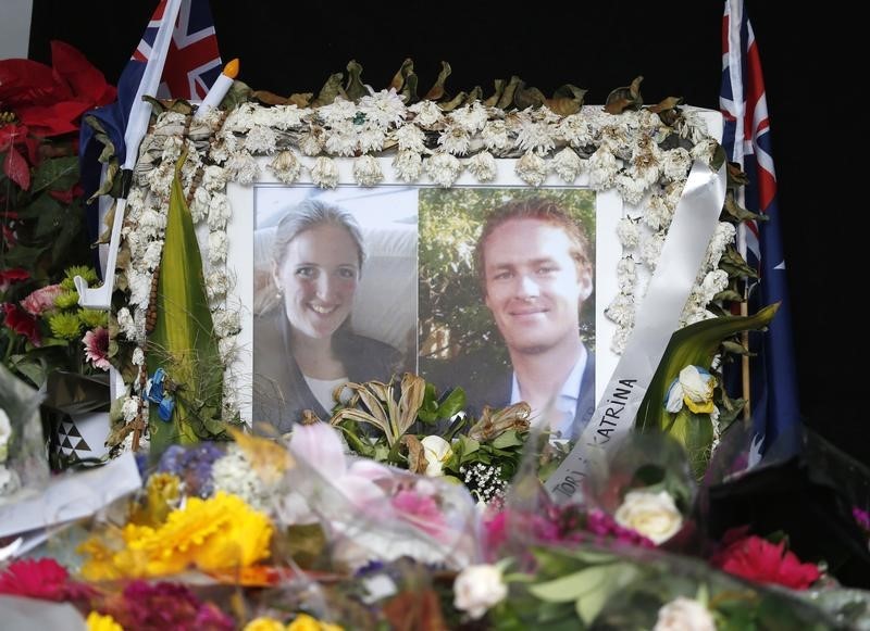 © Reuters. Photographs of Sydney's cafe siege victims, lawyer Katrina Dawson and cafe manager Tori Johnson are displayed in a floral tribute near the site of the siege in Sydney's Martin Place