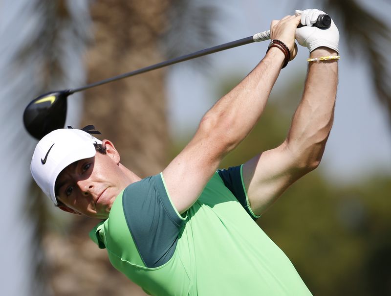 © Reuters. Rory McIlroy of Northern Ireland  tees off on the third hole during the Dubai Desert Classic