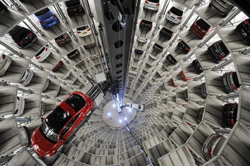 © Reuters. A Volkswagen "Beetle" (R) and an "UP!" are pictured in a delivery tower at the company's headquarter in Wolfsburg.