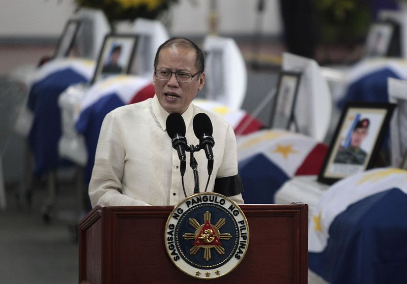 © Reuters. Philippine President Benigno Aquino delivers a speech in front of the caskets of the slain members of the Special Action Force (SAF) who were killed in Sunday's clash with Muslim rebels, during a service inside a police headquarters in Taguig city