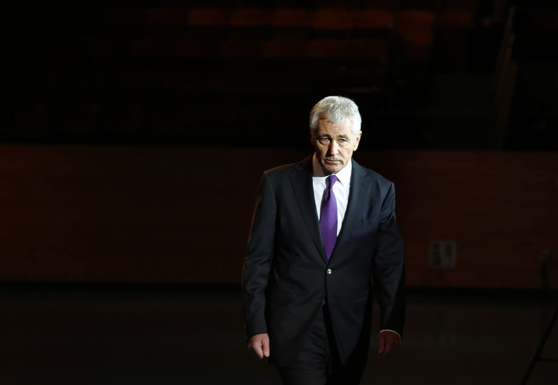 © Reuters. Hagel walks during a farewell ceremony in Virginia