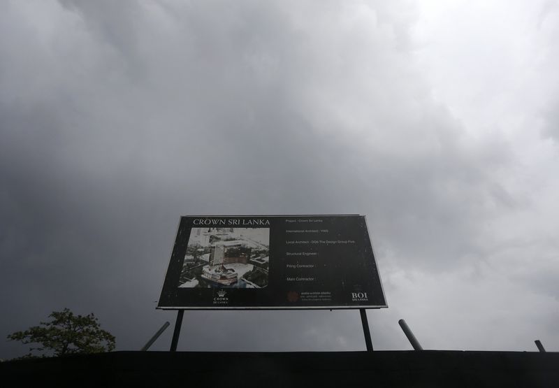 © Reuters. An advertising board for a proposed Crown resort and casino seen in front of the building site under dark clouds in Colombo