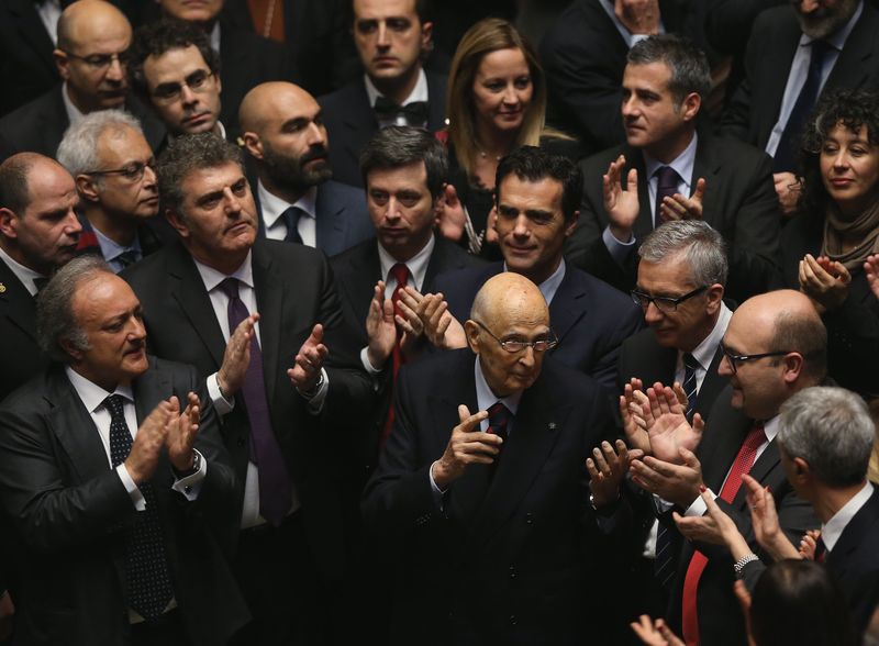 © Reuters. Outgoing Italian President Napolitano gestures as members of the Italian Parliament celebrate, after the election of the Italy's new President Mattarella, in the lower house of the parliament in Rome