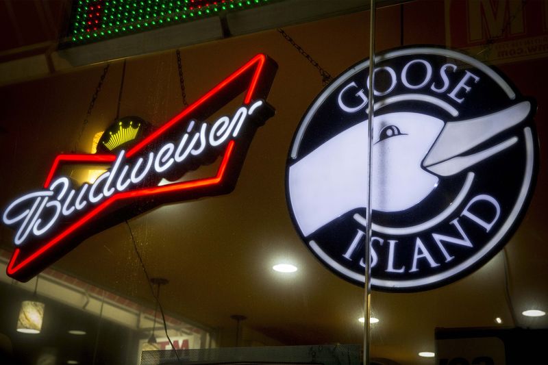 © Reuters. A Budweiser sign is displayed along side a sign for Goose Island beer at a store in Brooklyn, New York