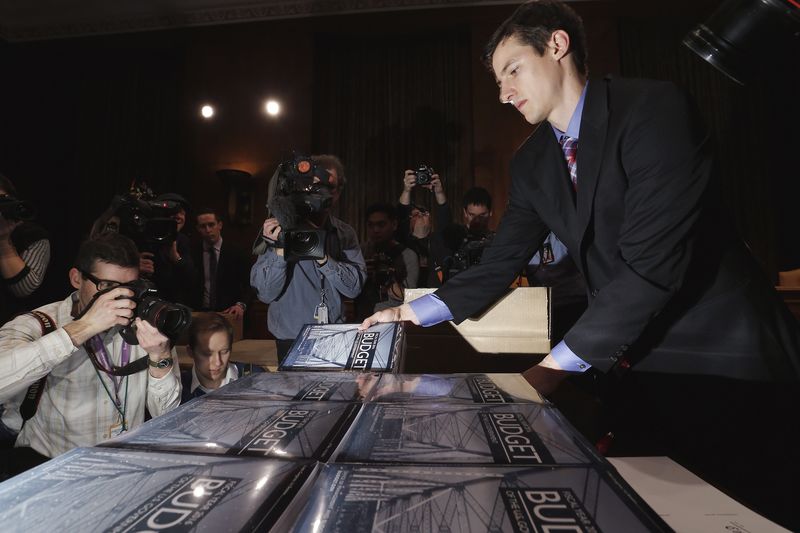 © Reuters. Chalmers unpacks printed copies of Obama's proposed 2016 budget to distribute to Senate staff members on Capitol Hill in Washington