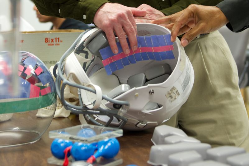 © Reuters. File photo of Subhash and Peters showing how their fluid-filled pouches will fit inside football helmets to prevent concussions in their lab at the University of Florida in Gainesville