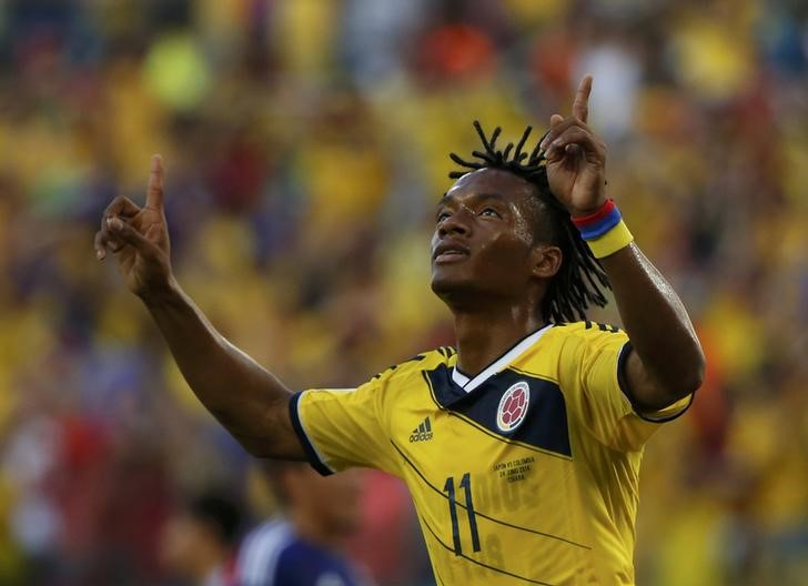 © Reuters. Colombia's Juan Cuadrado celebrates after scoring a penalty goal against Japan during their 2014 World Cup Group C soccer match at the Pantanal arena in Cuiaba