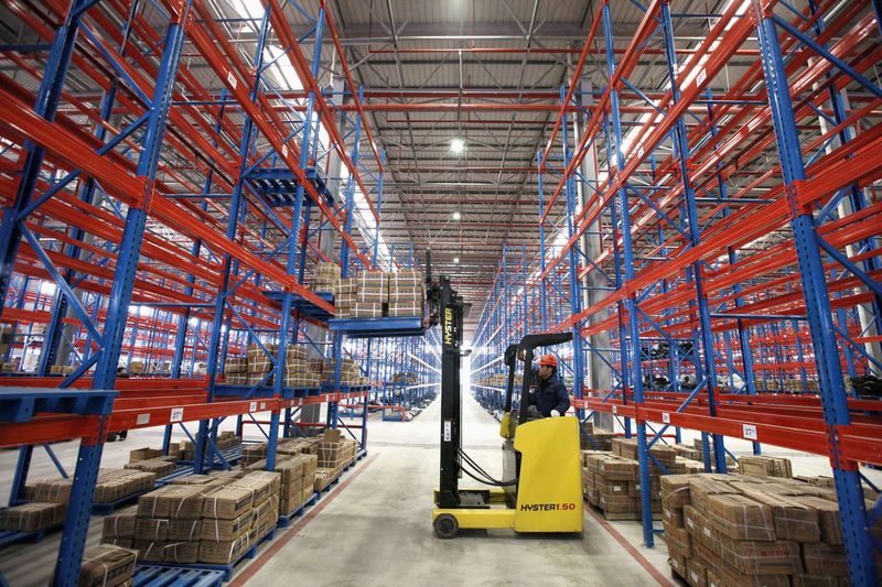 © Reuters. An employee works at a logistic center in Huaibei