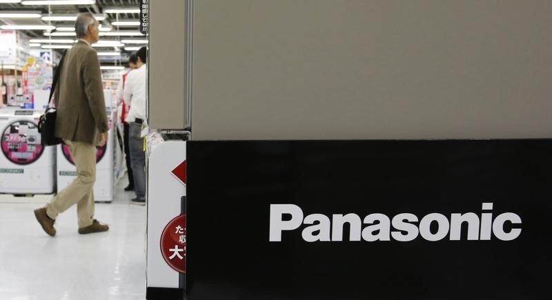 © Reuters. A man walks near a logo of Panasonic Corp at an electronics store in Tokyo