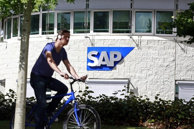 © Reuters. A man cycles past the SAP logo at its offices in the CityWest complex, Dublin