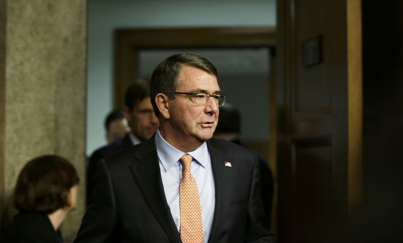 © Reuters. U.S. defense secretary-nominee Carter re-enters Senate Armed Services Committee room after break in his confirmation hearing on Capitol Hill in Washington