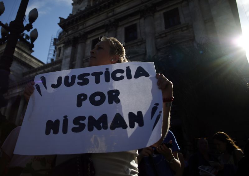 © Reuters. A woman holds a sign during a demonstration outside Argentina's Congress in Buenos Aires