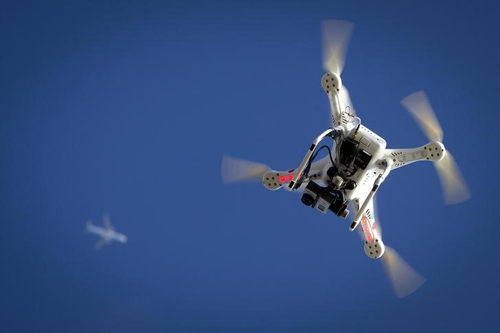 © Reuters. Airplane flies over a drone during the Polar Bear Plunge on Coney Island in the Brooklyn borough of New York