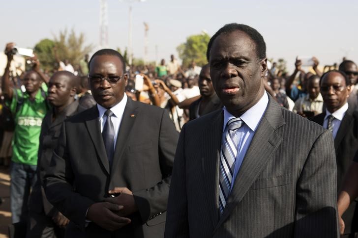 © Reuters. Burkina Faso President Michel Kafondo and PM Isaac Zida arrive at a memorial service for six people who died during the recent popular uprising in Ouagadougou