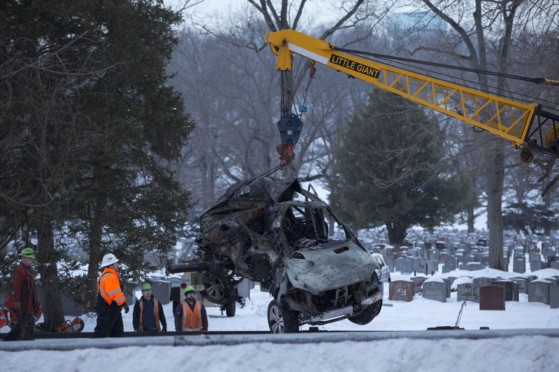 © Reuters. The vehicle that was struck by a commuter train is lifted from the tracks in Mount Pleasant, near Valhalla, New York