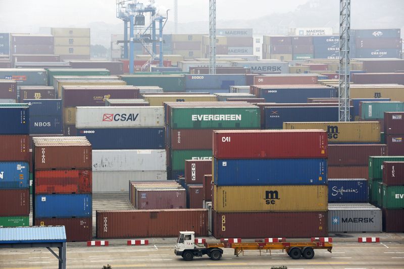 © Reuters. A trailer loaded with container boxes travels in Ningbo port