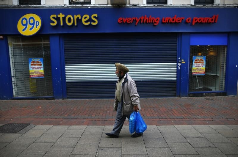© Reuters. A man walks past a closed discount shop in Chatham