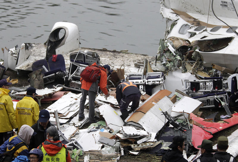 © Reuters. Equipes de resgate examinam os destroços do voo GE235 da TransAsia Airways 