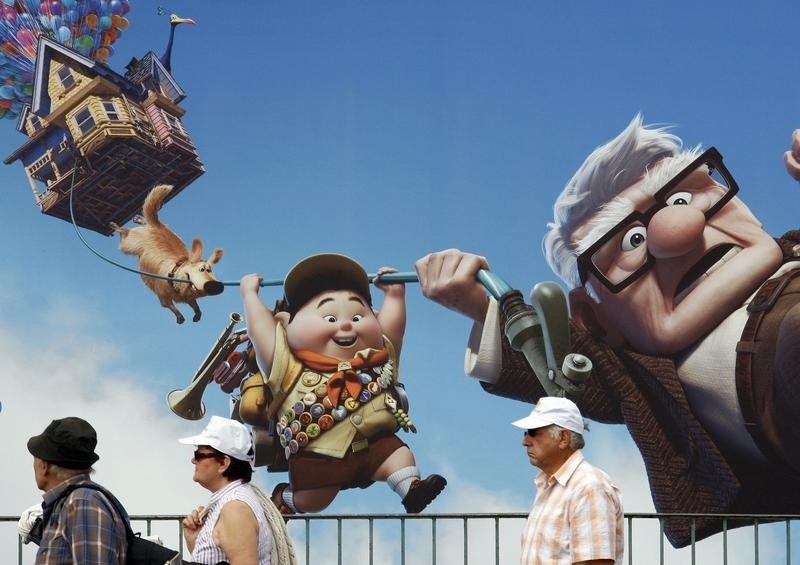 © Reuters. People walk past a giant advertising board for the animated film "Up"  in front of the Carlton Hotel in Cannes