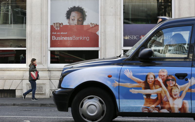 © Reuters. A woman walks past a branch of HSBC bank in London