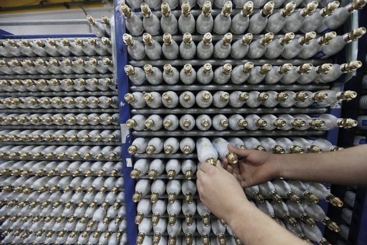 © Reuters. An employee sorts carbonator bottles while working at the SodaStream factory in the West Bank Jewish settlement of Maale Adumim